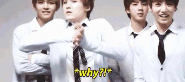 a group of young men are standing next to each other and one of them is asking why ?