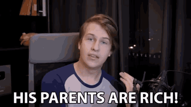 a young man sitting in front of a microphone with the words his parents are rich above him
