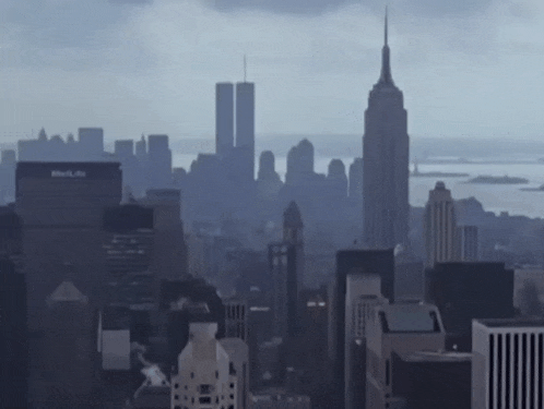 a city skyline with the empire state building in the background