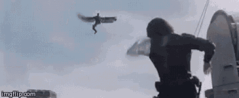 a man is running away from a helicopter that is flying overhead .
