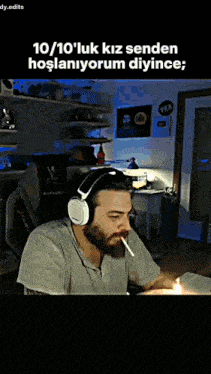 a man wearing headphones is smoking a cigarette in front of a computer screen .