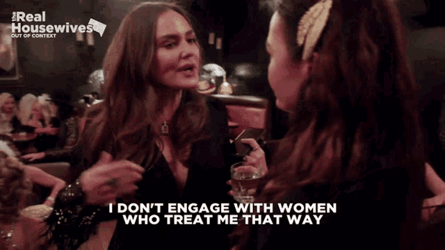 two women talking in front of a sign that says i don t engage with women who treat me that way
