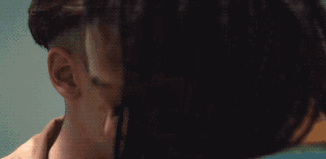 a close up of a man and woman kissing with their eyes closed