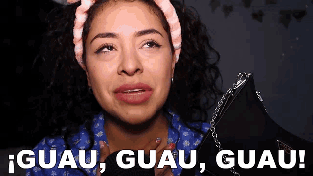 a woman wearing a headband and a blue shirt says guau guau guau