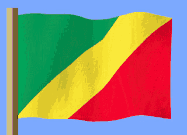 a green yellow and red flag is waving on a pole