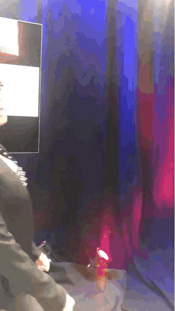 a blurry picture of a person standing in front of a tv