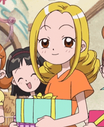 a girl in an orange shirt is holding a gift box in her hand .