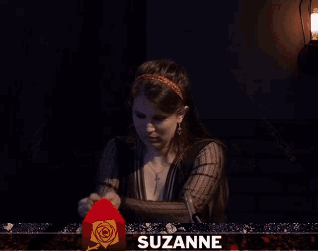 a woman stands in front of a screen with the name suzanne