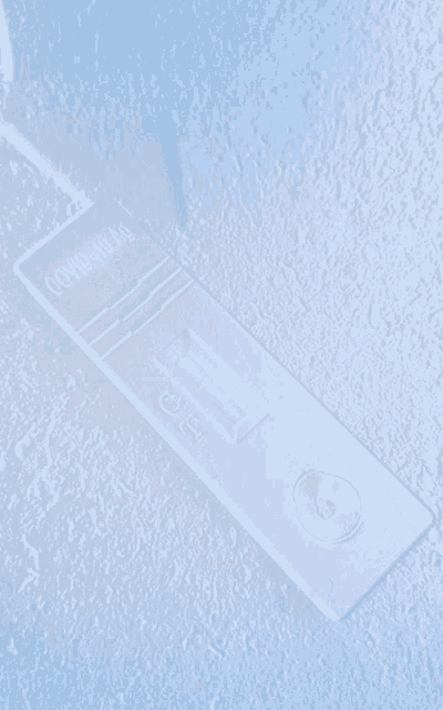 a close up of a covid-19 test on a blue background