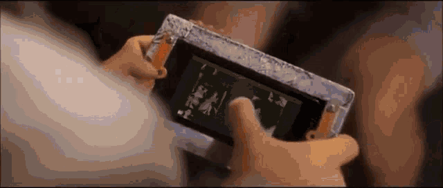 a person is holding a cell phone with a green screen .