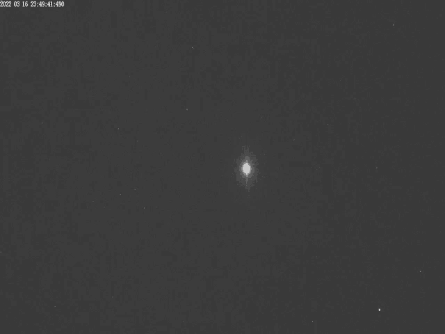 a black and white photo of a star in a dark night sky .