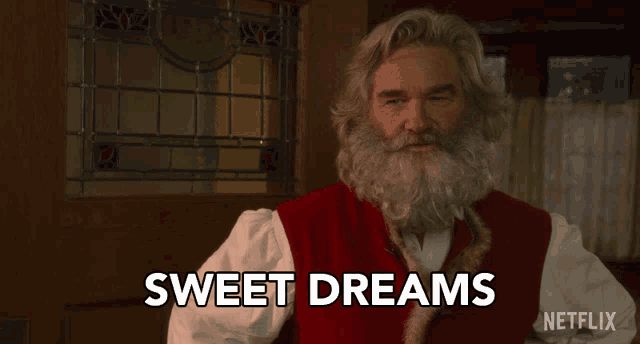 a man with a beard says sweet dreams in front of a window
