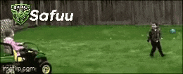 a girl is riding a lawn mower while a boy kicks a ball in the grass .