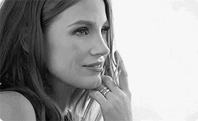 a woman is talking on a cell phone and wearing a ring on her finger .