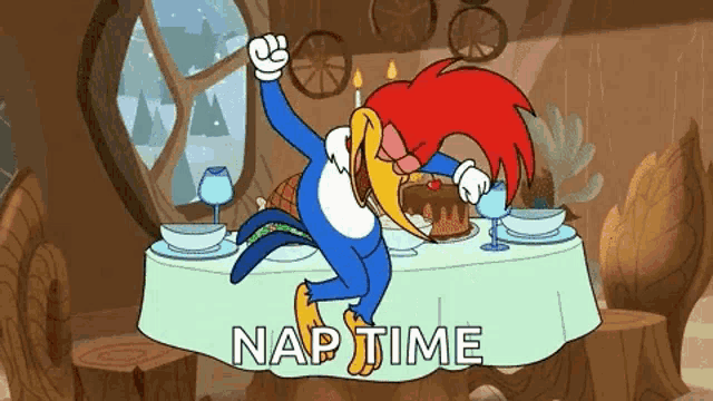 woody woodpecker is sitting at a table with a cake and candles .