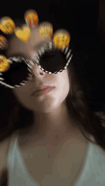 a blurry picture of a woman wearing sunglasses with hearts on them