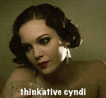 a woman holding a glass of wine with the name thinkative cyndi written below her