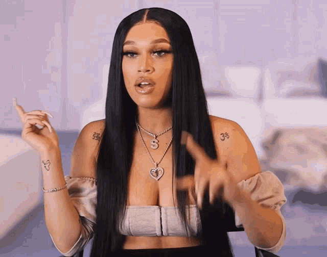 a woman with long black hair has a tattoo on her arm that says 3