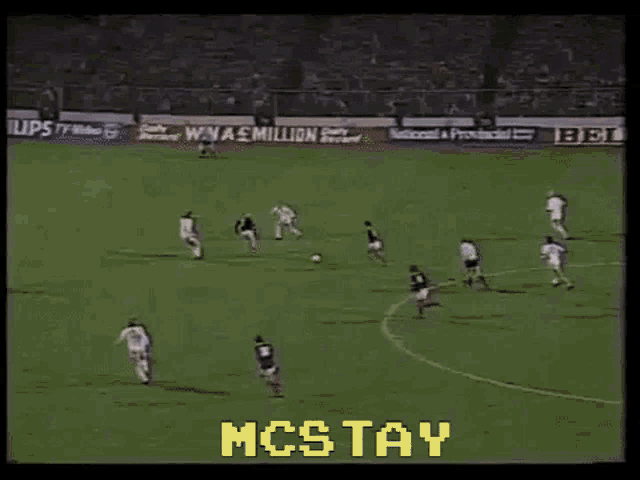 a blurred image of a soccer field with the words mcstay on the bottom right