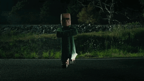 a person is flying through the air on a road at night