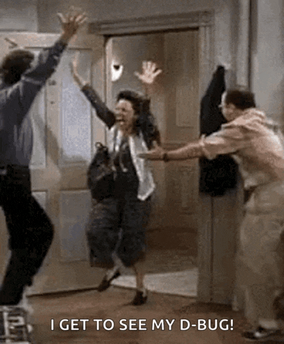 a man and a woman are jumping in the air in a room .