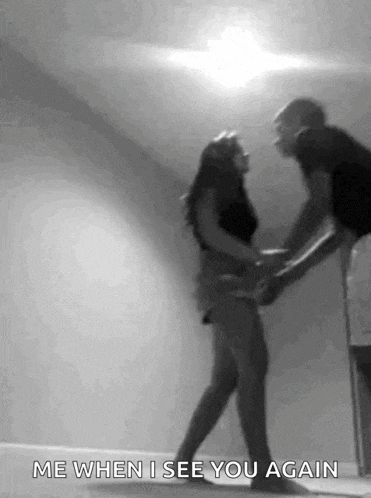 a man is holding a woman 's hand in a black and white photo and says `` me when i see you again ''