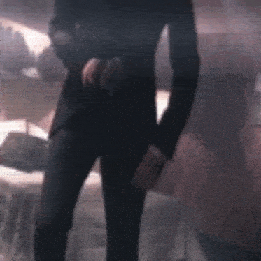 a blurry image of a bedroom with a bed and a lamp