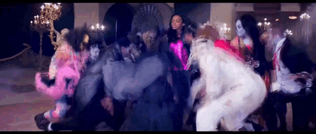 a group of people dressed in costumes are dancing together