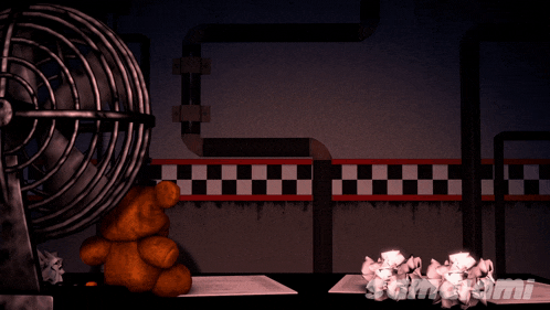 a teddy bear sits next to a fan in a room with some crumpled paper