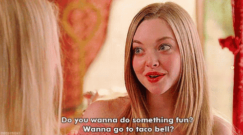 a woman is talking to another woman in front of a mirror and asking her if she wanna do something fun .