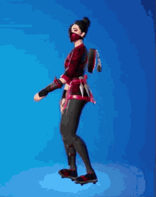 a woman in a red and black ninja outfit is standing on a blue background .