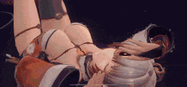 a woman in a bikini is laying on her back in a dark room