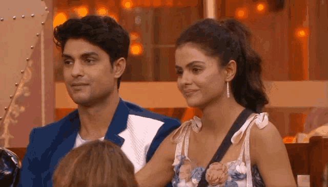 a man and a woman are sitting next to each other on a stage