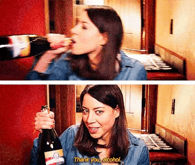 a woman is holding a bottle of alcohol and says thank you alcohol