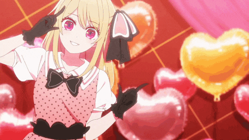 a girl in a pink dress is standing in front of balloons in the shape of a heart