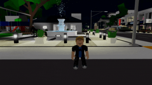 a boy in a video game standing in front of a fountain