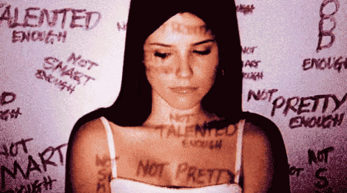 a woman is standing in front of a wall that says not smart enough