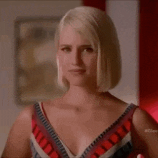 a woman in a striped dress is standing in a room .