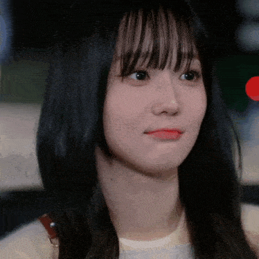 a close up of a woman 's face with long black hair