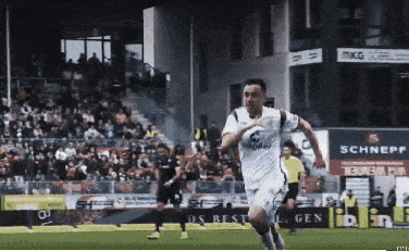 a soccer player wearing a white shirt with the number 6 on it