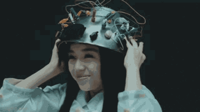 a woman is wearing a helmet with wires on it