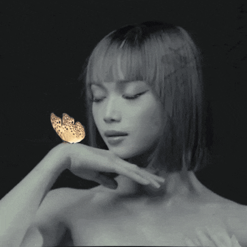 a woman with a butterfly on her hand