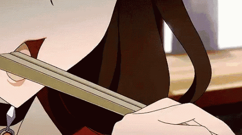 a close up of a person eating food with chopsticks .