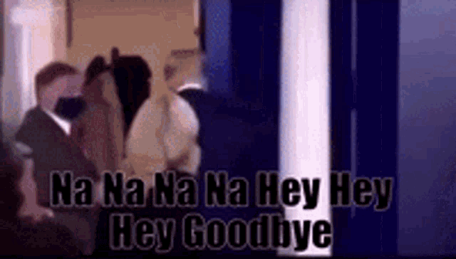 a group of people are standing in a room with the words `` hey goodbye '' written on the bottom .