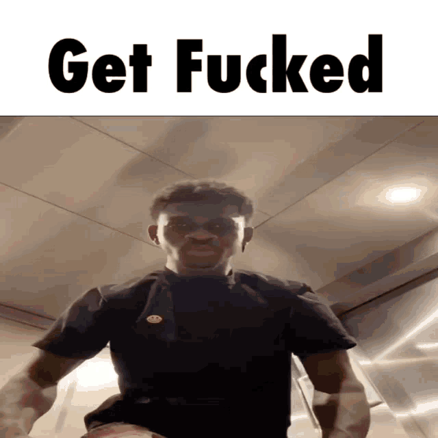 a man is standing in front of a sign that says " get fucked "