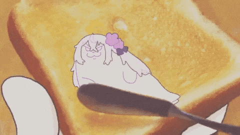 a cartoon character is being spread on a piece of toast .