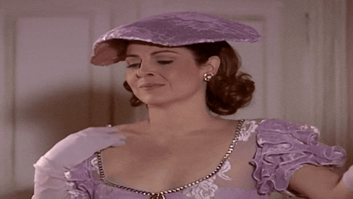 a woman in a purple dress and purple hat