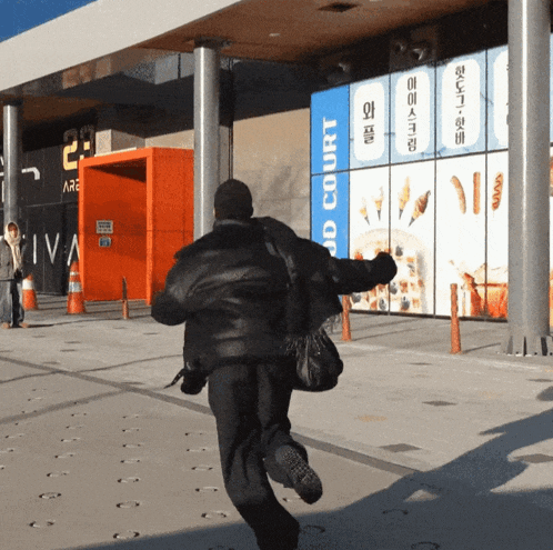 a man running in front of a food court