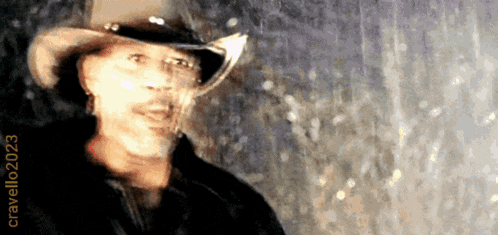 a blurry picture of a man in a cowboy hat with the year 2023 on the bottom right