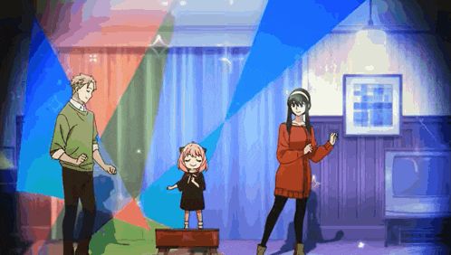 a man a woman and a little girl are standing on a stage